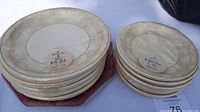 Set of 5 packages of dinner plates and 5 packages of dessert plates, each containing 8 plates with off-white floral border design