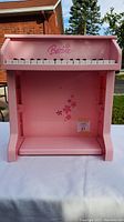 Front view of pink Barbie toddler piano showing keyboard and Barbie logo.
