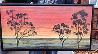 Front view of large rectangular tree landscape artwork with vibrant sunset colors