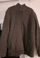 Full view of men's brown wool blend sweater hanging, showing front zipper and ribbed collar and cuffs.