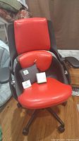 Red and black ALL33 Axion BetterBack ergonomic office chair showing vegan leather cushions and adjustable armrests