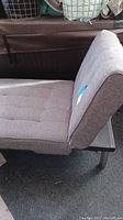 Side view of tussled heather gray fabric chaise lounge chair showing the adjustable backrest in upright seating position, with visible metal frame base.