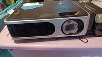 Front view of Toshiba projector showing lens and vent.