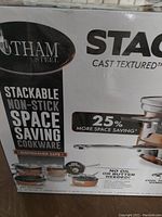 Photo shows Gotham Steel logo and product callouts including stackable non-stick space saving cookware, dishwasher safe, and 25% more space saving claim.