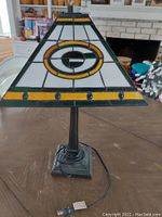 Tiffany style lamp with Green Bay Packers logo facing front, showing stained glass detail.