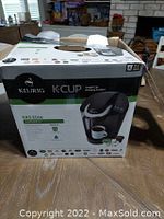 Box front showing the brand Keurig, model K45 Elite, and functions of the automatic single cup brewing system. Includes bonus 12 K-Cup pods.