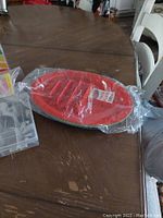 Red plastic taco plates wrapped in packaging