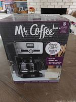 Front of the box showing Mr Coffee Advanced Brew coffee maker, digital display and control panel.