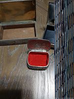 Open square trinket box showing red velvet lining inside with silver or silver-plated exterior and visible detailing