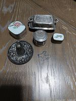 Overview of five trinket boxes showing shapes, lids, and general condition