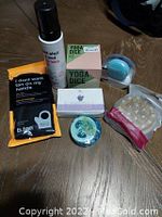 Lot contents including sunless tanning lotion, Yoga Dice Kit, detox brush, various soaps, and tanning mitt