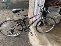 Full side view of bike leaning against garage wall