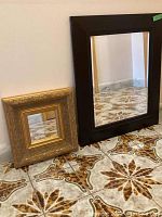 Both mirrors positioned on a tiled floor against a wall showing size and styles