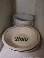 Three large serving bowls stacked, one labeled 'Pasta' in green with green rim stripes.