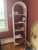 Front view of white wicker shelf with all contents visible