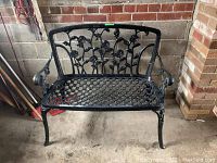 Front view of black wrought iron bench with rose motif and lattice seat