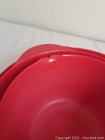 Close-up of the red mixing bowl showing a chip on the rim.
