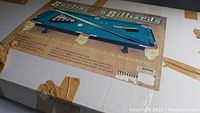 Box of miniature Burlington Billiards playing pool table with image and product information visible.