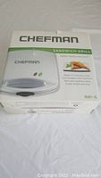 Box of Chefman sandwich grill with product image and description on box front.