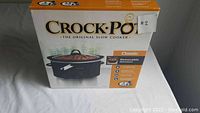 Photo of the boxed Crock-Pot slow cooker showing the front with brand name, product image and label #2.