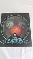 Vinyl collectible of Disney Shorts showing red vinyl ball with Ariel signature and blue Mickey ear figures with Flounder and Sebastian