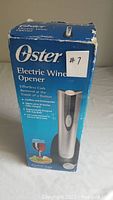 Front of the original Oster Electric Wine Opener box showing product details and condition as new.