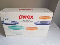 The unopened box showing the 10 piece Pyrex glass storage bowl set with various colored lids.