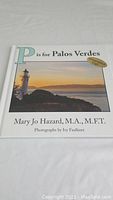 Front cover of the book showing title, author, and photograph of a lighthouse at sunset.