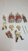 Collection of Star Wars action figures and accessories shown on white background, items partially broken and incomplete.
