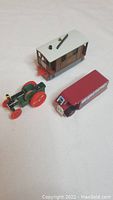 Three piece Thomas the Tank Engine set including tractor, caboose, and passenger carriage