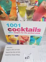 Photo of the '1001 Cocktails' hardcover book featuring colorful cocktail images on the cover and the title prominently displayed.