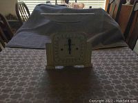 Mechanical scale displayed on table showing front dial with markings and pointer at zero.