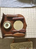 Top-down photo of wooden plaque with weather dial and round mirror, showing the complete mounted setup.