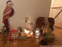 Lot arrangement with various nature-themed decorative items including stained glass bird, figurine, lantern, birdhouse and butterfly night light.