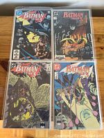 Four Batman Year 3 comic books in plastic sleeves with various Batman-themed covers showing wear from use and storage.