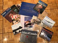 Full view of the assorted magazines and booklets spread on the floor showcasing variety and condition.