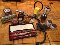 Full lot of vintage camping lanterns, assorted tins, spray bottle, magnifying glass, shoehorn, comb, jars, bird figurine, and cutlery set in case