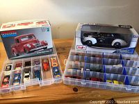 First photo showing model kit box, boxed police car, and two storage cases with multiple Hot Wheels diecast cars.