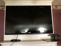 Front view of the Samsung 46" flat screen TV mounted on a wall or placed on a mantel with the Samsung logo visible below the screen.