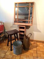 Full set of items including wood-framed wall mirror with wine rack, wooden stool, metal bucket, and metal pitcher shown on floor and wall.