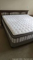 Full view of bed frame, headboard and mattress from left corner