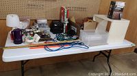 Overview of folding table with assorted hardware and tools arranged on the surface.