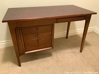 Front angled view showing overall desk design and drawer configuration