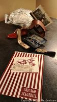 Overall assortment of items including stereoscope, glasses, hatpins, choker, christening gown, and stagebill with ticket