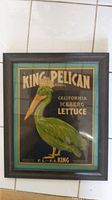 Front view of framed vintage advertising art with King Pelican brand and a crowned pelican illustration.