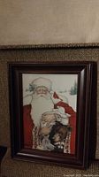 Full view of the framed picture depicting St. Nick with a child and animals in his arms.