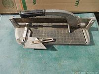 Full view of the Q.E.P. Super Tile Cutter showing handle, cutting base and guide mechanism.