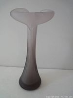 Full front view of the lavender frosted Jack in the Pulpit vase showing its tall, narrow base and wide, curved top.