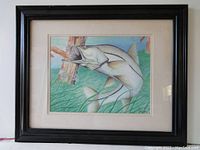 Framed lithograph showing the full artwork including the black wooden frame and beige mat.