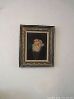 Frontal view of framed vintage oil painting showing the old man portrait, signature, and frame details.